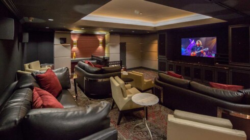 Movie theater style room with seating and tables