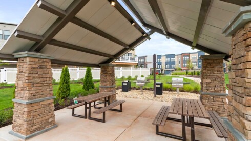 Outdoor bench seating behind City Center Townes with awning cover