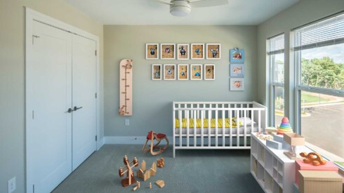 Second bedroom view with crib and small toys