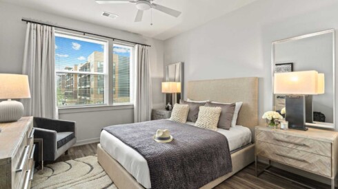 Master bedroom with natural lighting and large window view